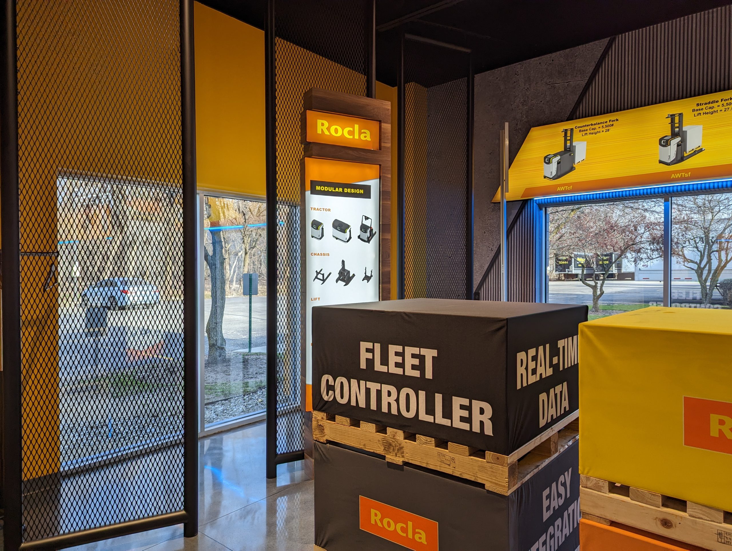 Logisnext showroom wide view with branded graphics and equipment displays