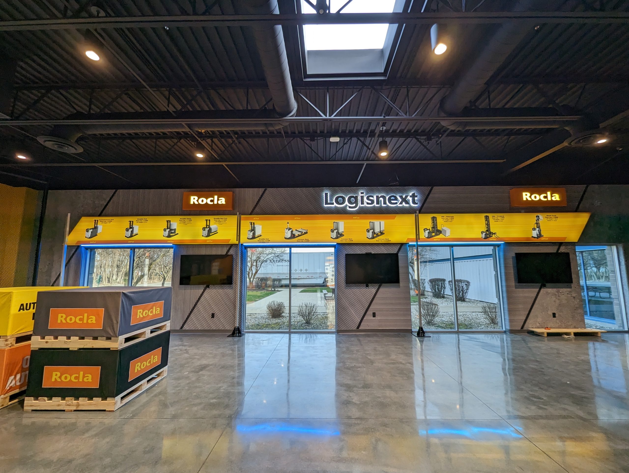 Rocla and Logisnext branded showroom environment with dual-brand product displays