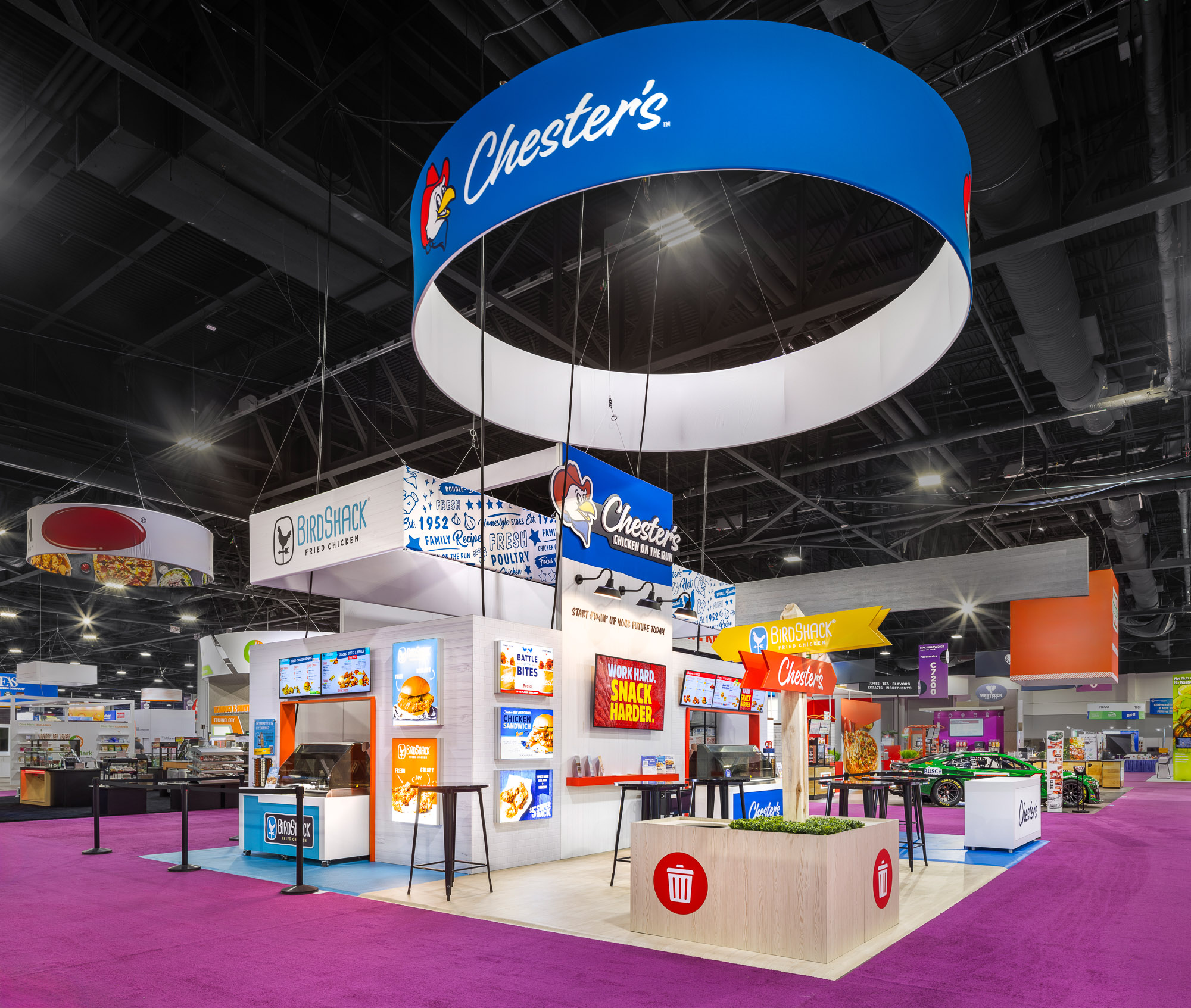 Chester's Chicken booth detail showing branded graphics and backlit signage