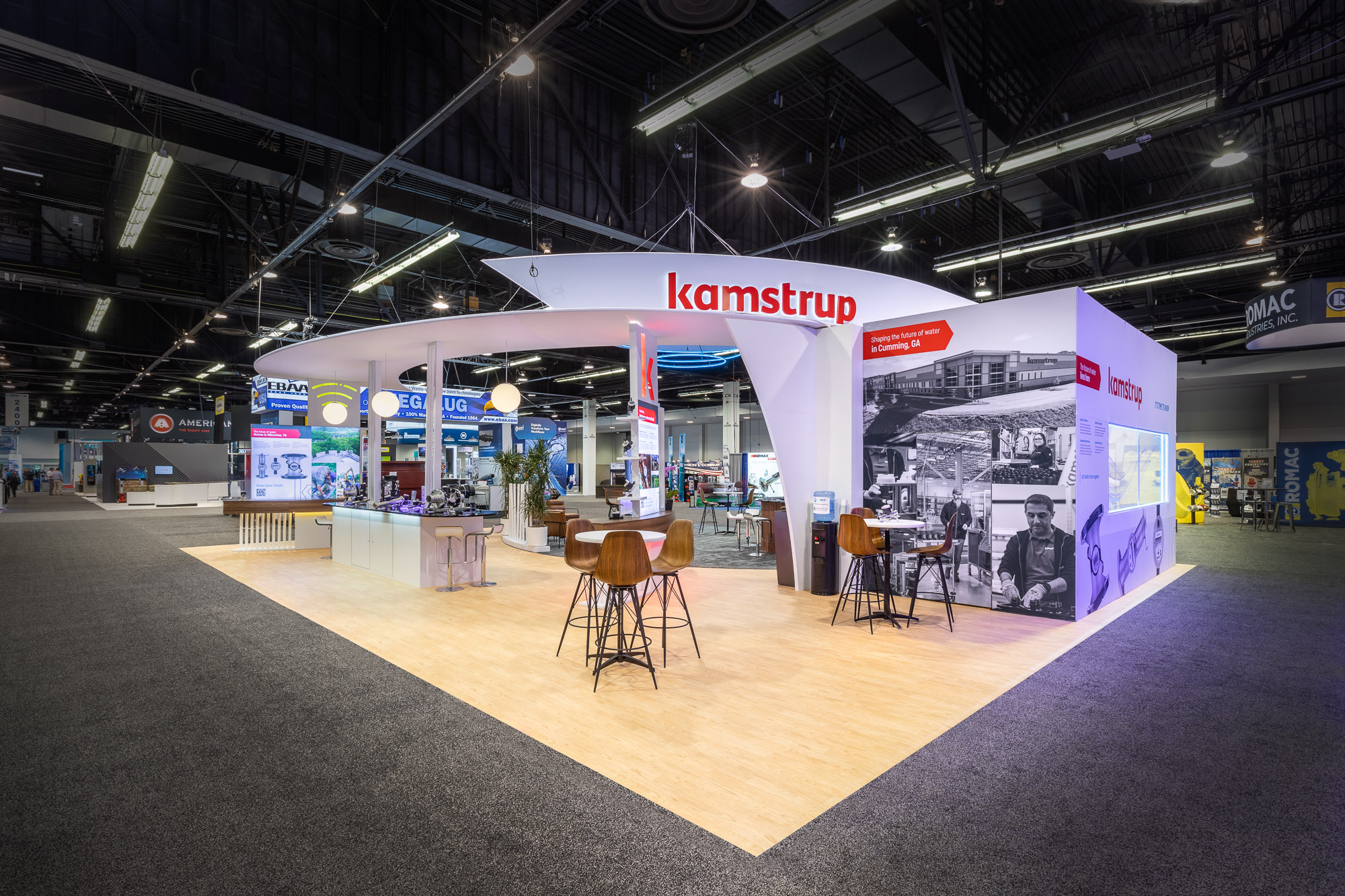 Kamstrup booth meeting area with warm wood accents